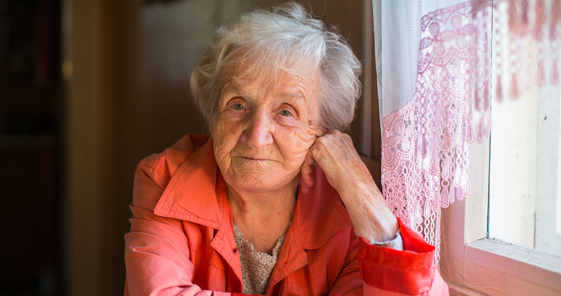 Elderly woman sitting at a table 